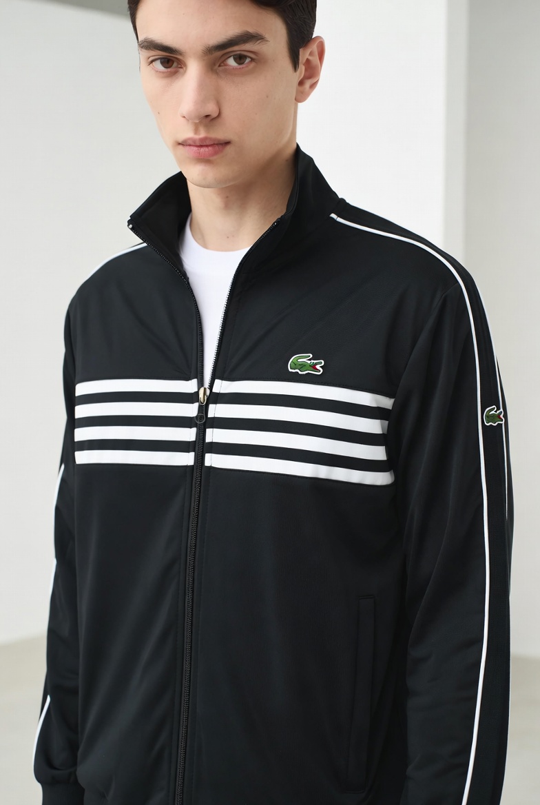 Model wearing a signature black jacket in an urban setting